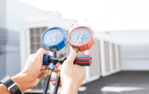 Technician is checking air conditioner ,measuring equipment for filling air conditioners. Cooling system