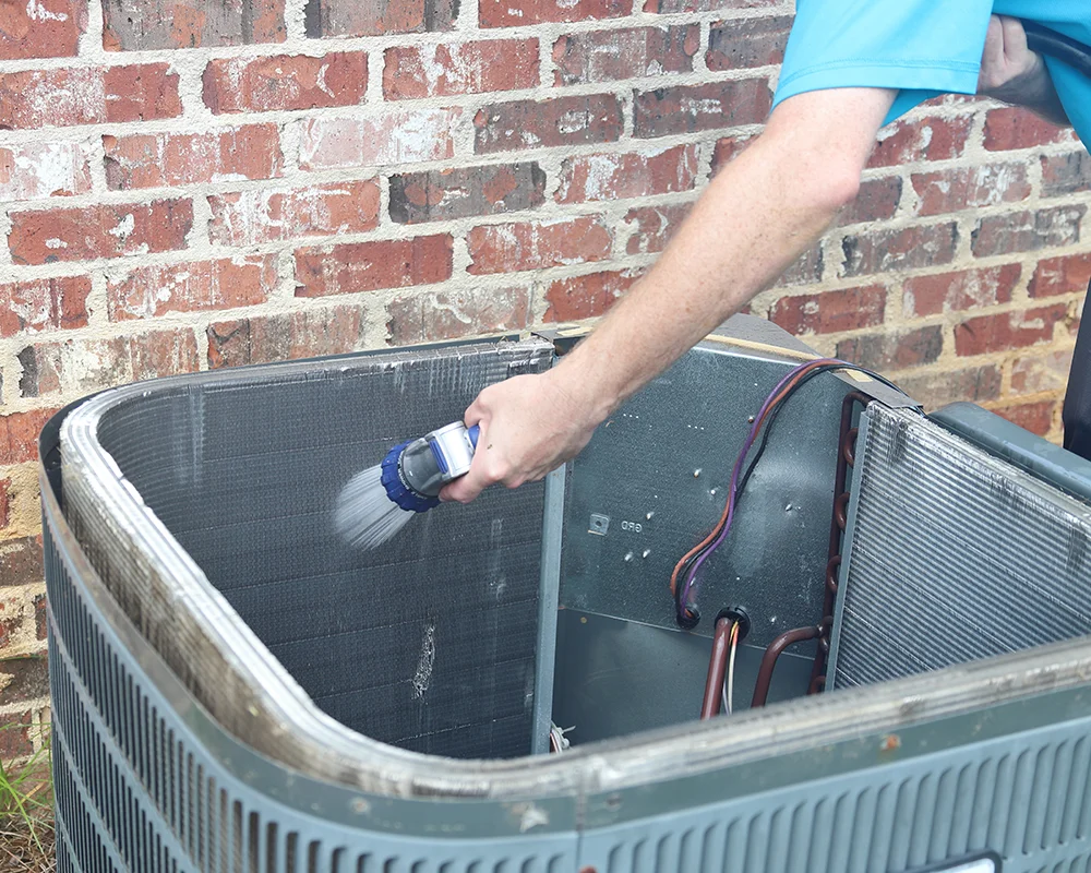 Cleaning an air conditioning unit with a hose