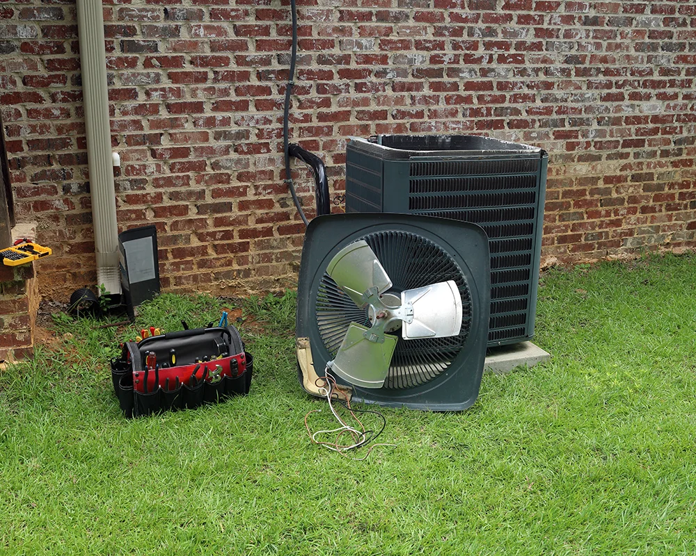 An air conditioning unit is disassembled for repair and servicing