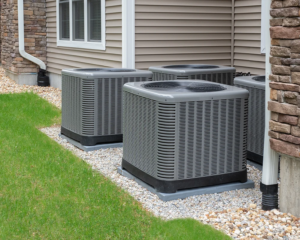 4 air conditioning units outside a housing complex