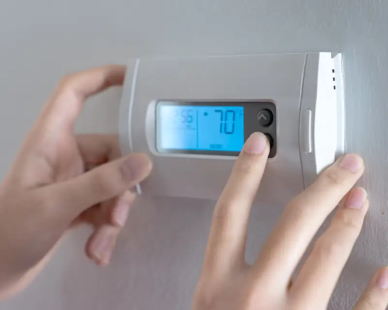 Setting the temperature on a home thermostat